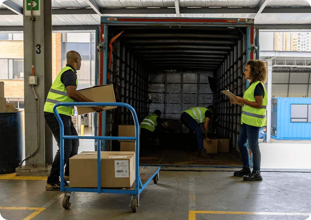 Image: People loading a truck at a loading dock.