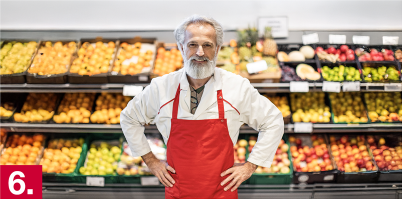 Image: A man standing in front of produce.
