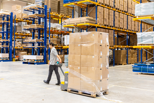 Image: A man pulling a palett of boxes in a warehouse. Links to BJ's home page.